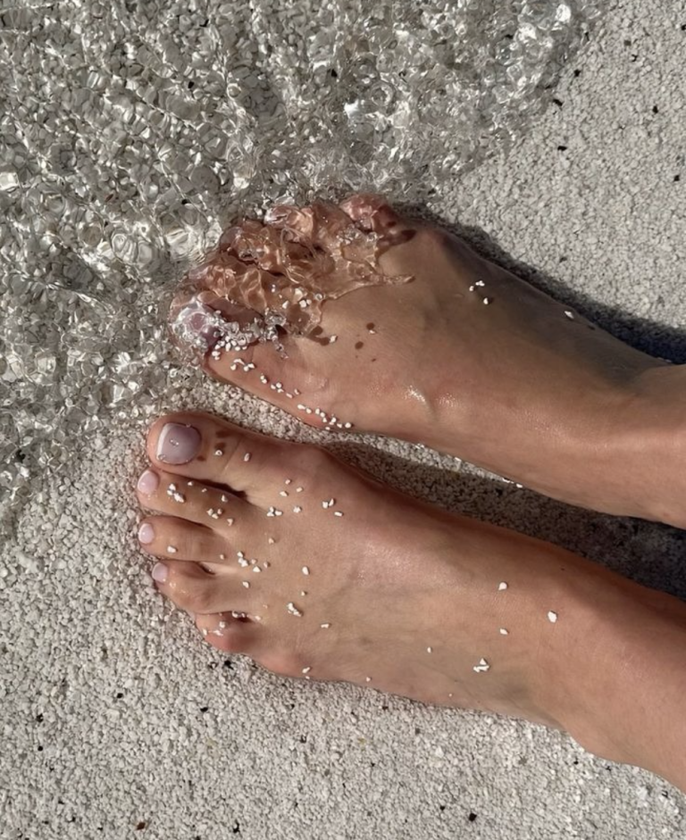 Summer foot care with feet in open footwear outdoors